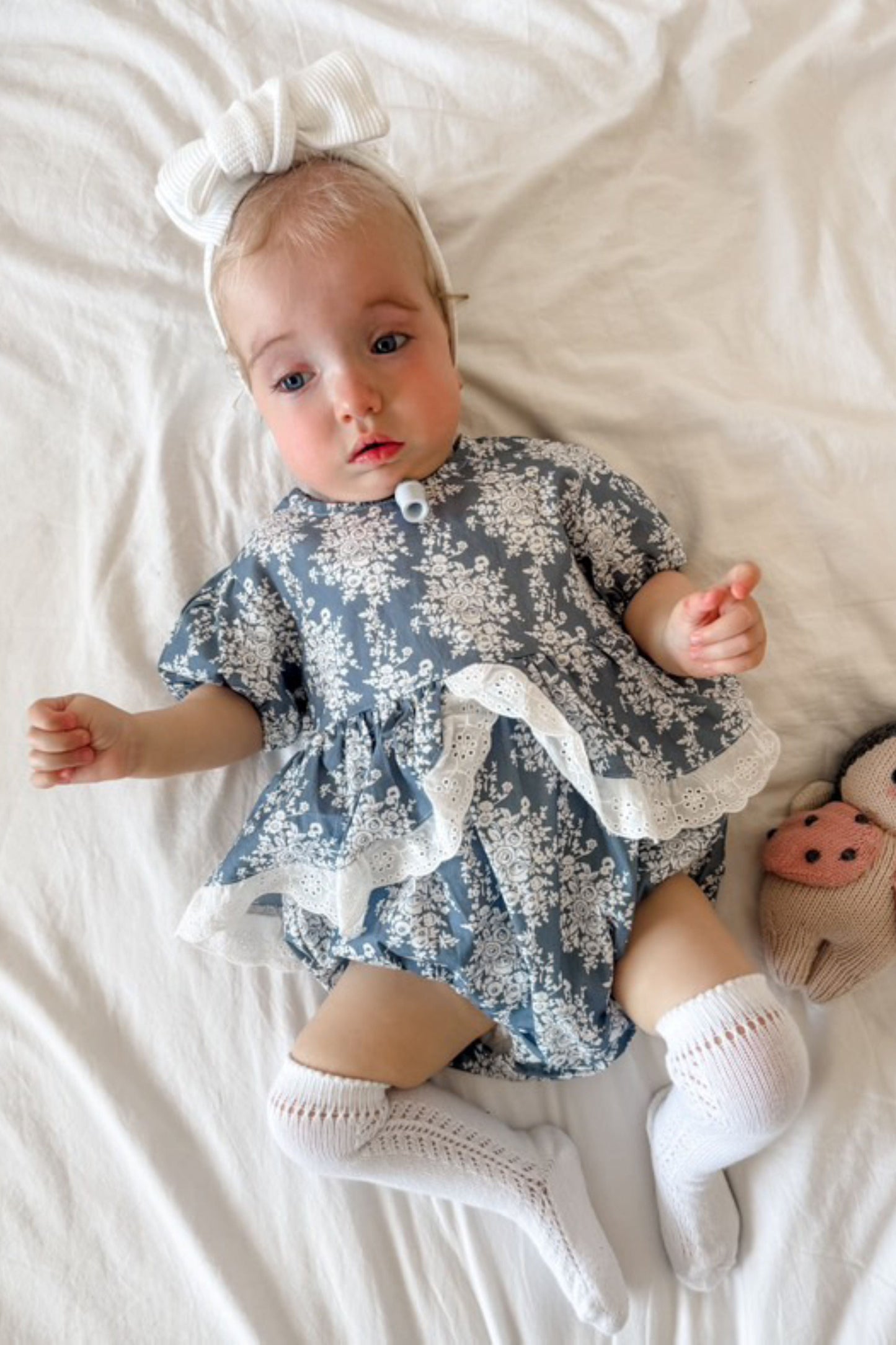 Baby girls blue and white floral romper with broderie detail ruffle